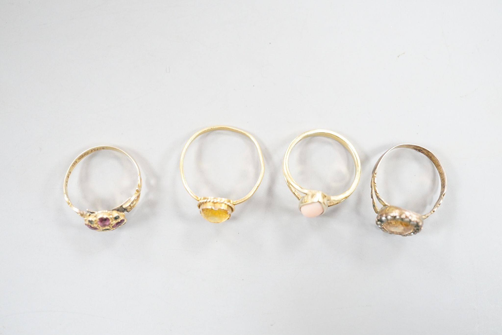 A late Victorian 15ct gold and two colour garnet set cluster ring (a.f.), size N, gross 2.2 grams, two other yellow metal and gem set rings including 19th century, gross 4.4 grams and one other ring.